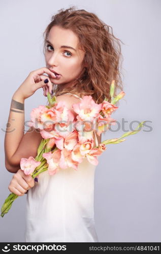 Stylish portrait of a young woman with a bouquet of flowers.