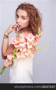 Stylish portrait of a young woman with a bouquet of flowers.