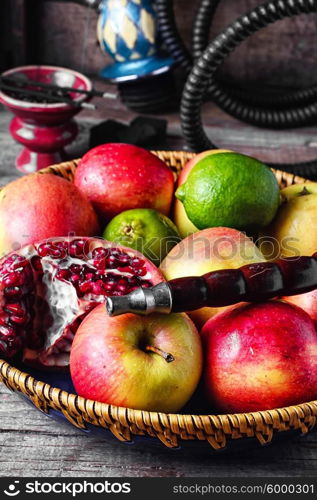 Stylish Smoking hookah and basket with apples,pomegranate and lime