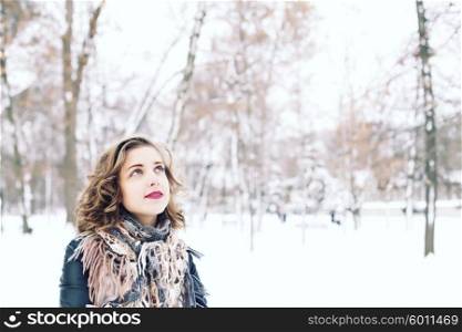 stylish street fashion concept - young slim blond woman with purple lips and curly hair posing in the street in winter. hair care, fashion bob hairstyle. hipster girl outdoors