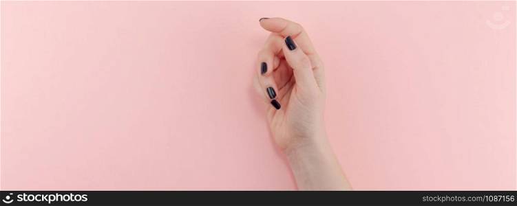 Stylish trendy female black manicure. Beautiful young woman&rsquo;s hands on millennial pink pastel background. Beauty and SPA concept. Banner Template for feminine blog social media