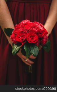 Stylish wedding bouquet bride of pink roses, white carnation and green flowers and greens with ribbons lying. Close up. Side view. Wedding decor. Artwork. beautiful wedding bouquet. beautiful wedding bouquet. Stylish wedding bouquet bride of pink roses, white carnation and green flowers. Side view. Wedding decor.