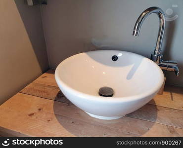 Stylish white sink, luxury white porcelain sink on wooden table bathroom modern. Stylish white sink, luxury white porcelain sink on wooden table bathroom