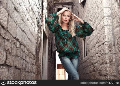 Stylish woman between two ancient buildings