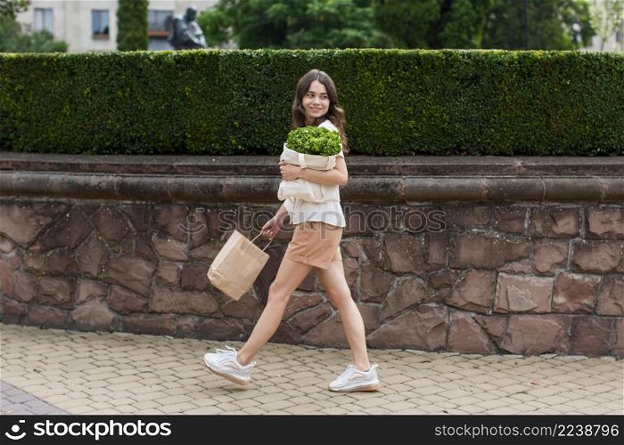 stylish woman carrying groceries bag