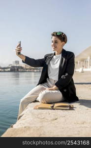 stylish woman checking her phone outdoors