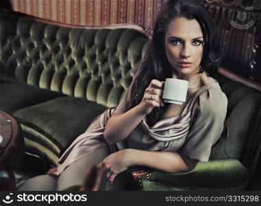 Stylish woman drinking coffee