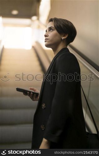 stylish woman escalator looking away