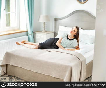 Stylish woman lying in the fancy bedroom