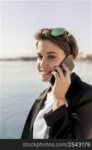 stylish woman talking phone outdoors