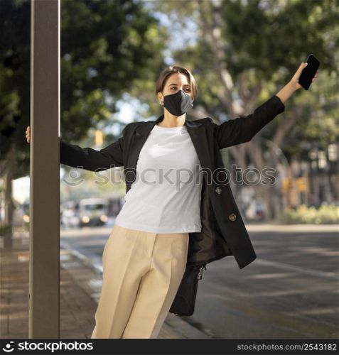 stylish woman wearing medical mask outside 2
