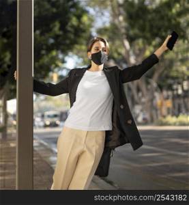 stylish woman wearing medical mask outside 2