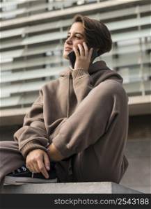 stylish woman wearing sportswear talking phone