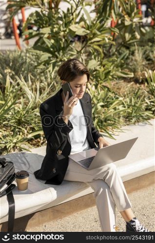 stylish woman working laptop outdoors 2