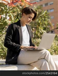 stylish woman working laptop outside
