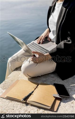 stylish woman working outside sunny day