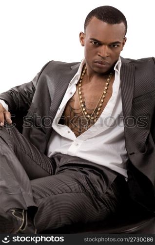 Stylish young business man sitting on the couch on isolated white background
