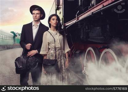 Stylish young couple on vintage railroad station