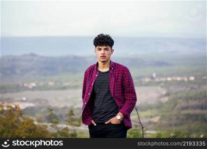 stylish young handsome traveler man standing looking camera