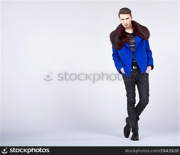 Stylish young man in a fashion pose