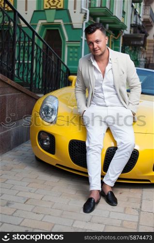 Stylish young man posing with sport car