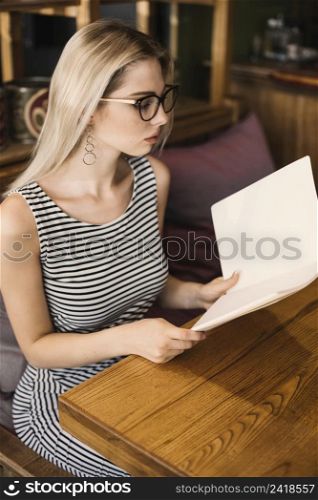 stylish young woman checking menus restaurant