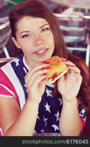 Stylish young woman eating at a cafe