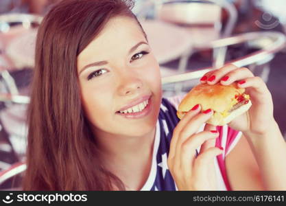 Stylish young woman eating at a cafe