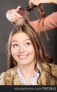 Stylist curling hair for young woman.. Stylist curling hair for pretty woman. Girl care about her hairstyle