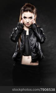 Subculture beauty punk girl in leather jacket black background