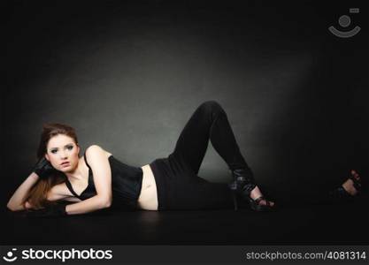 Subculture, beauty punk or rocker style girl in full length on black background