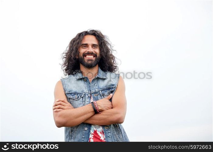 subculture, youth culture and people concept - smiling young hippie man in demin vest