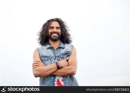 subculture, youth culture and people concept - smiling young hippie man in demin vest
