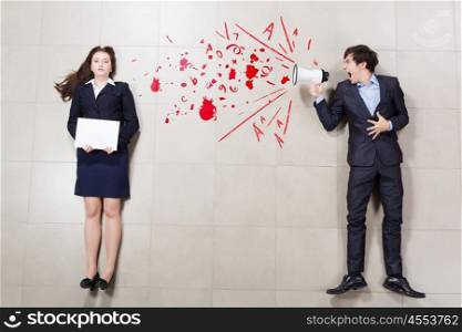 Subordination concept. Angry businessman shouting in megaphone on his colleague