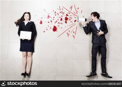 Subordination concept. Angry businessman shouting in megaphone on his colleague