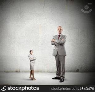 Subordination concept. Miniature of young businesswoman and bossy businessman