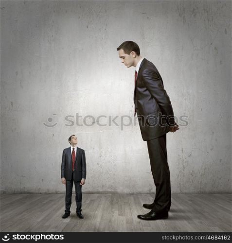 Subordination concept. Two businessman of different size. Leadership concept