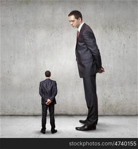 Subordination concept. Two businessman of different size. Leadership concept