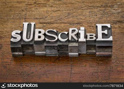 subscribe word in mixed vintage metal type printing blocks over grunge wood