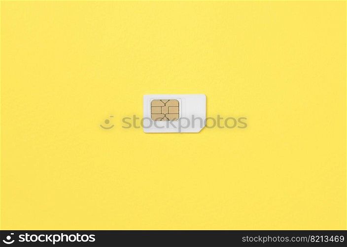 Subscriber identity module. New white SIM card on bright yellow color background. Minimal flat lay top view. Subscriber identity module. White SIM card on yellow background