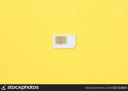 Subscriber identity module. New white SIM card on bright yellow color background. Minimal flat lay top view. Subscriber identity module. White SIM card on yellow background