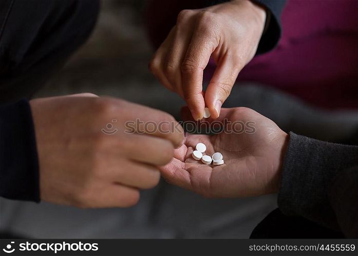 substance abuse, addiction and people concept - close up of addicts using drugs outdoors