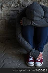 substance abuse, addiction, people and social issue concept - close up of addict woman hiding her face on street