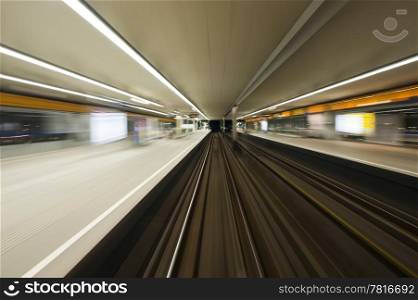 Subway train, driving at speed past a station
