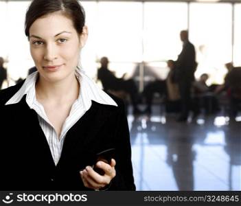 Succeful young businesswoman is posing in the lobby.