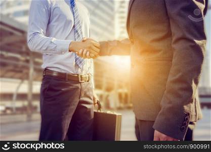 Success and Happiness concept, Business man handshake at city outside office.