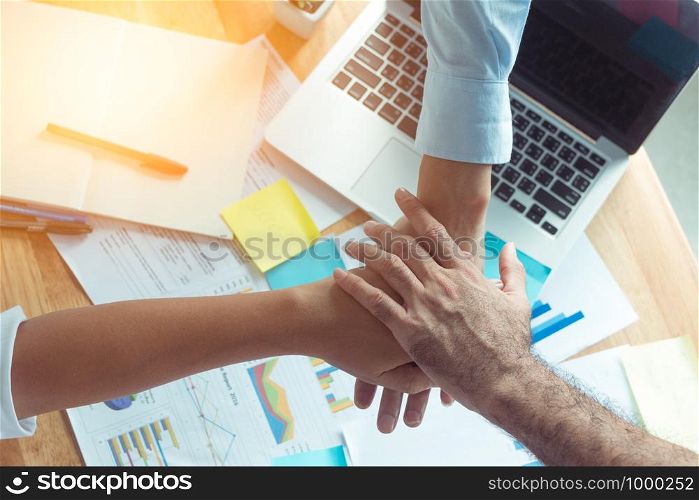 success and winning concept - happy business team giving high five in office business people join hand while meeting in office