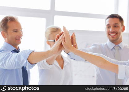 success and winning concept - happy business team giving high five in office