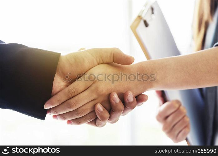Success business deal concept. Closeup of business people handshaking after finished deal in office.
