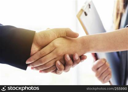 Success business deal concept. Closeup of business people handshaking after finished deal in office.